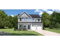 Charming two-story home with blue accents, a well-manicured lawn, and an attached two-car garage at 882 Nichols View Ct, Raleigh, NC 27604