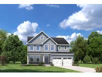 Charming two-story home with a two-car garage, well-manicured lawn, and beautiful landscaping at 884 Nichols View Ct, Raleigh, NC 27604