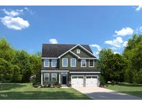 Charming two-story home with a well-manicured lawn, two-car garage, and classic architectural details at 892 Nichols View Ct, Raleigh, NC 27604
