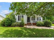 Charming single-story home with a welcoming front porch and well-maintained landscaping at 99 Winwood Dr, Angier, NC 27501