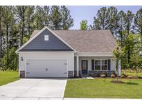 Charming single-Gathering home with a two-car garage, manicured lawn, and welcoming curb appeal at 1004 Rhino Bnd, Oxford, NC 27565