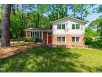 Charming two-story home with a brick and siding exterior and a bright red front door at 102 Emerald Cir, Durham, NC 27713