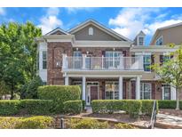 Beautiful brick townhouse with a charming balcony and well-manicured landscaping in a desirable neighborhood at 10511 Sablewood Dr # 107, Raleigh, NC 27617