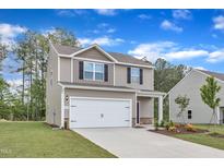 Charming two-story home featuring an attached two-car garage and beautifully landscaped front yard at 111 Rhino Bnd, Oxford, NC 27565