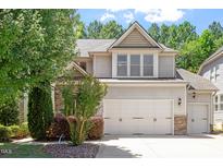 Charming two-story home with a three car garage and manicured landscaping at 1413 Lily Creek Dr, Cary, NC 27518