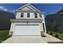 Charming two-story home with a two-car garage and manicured landscaping, perfect for suburban living at 154 N Finley Landing Pkwy, Smithfield, NC 27577