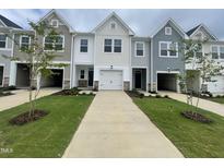 Charming new construction townhomes with attached garages and welcoming front yards at 231 Paramount Dr, Smithfield, NC 27577