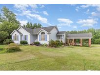 Charming single-Gathering home with a well-manicured lawn and a detached carport offering convenient parking at 2312 Buckstone Ct, Fuquay Varina, NC 27526