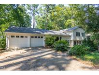 Charming home featuring an attached two-car garage and lush greenery at 256 Marilyn Cir, Cary, NC 27513