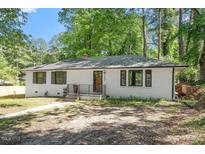 Charming single-story home featuring a brick facade, dark trim, and a well-manicured front yard at 2609 Elmhurst Cir, Raleigh, NC 27610