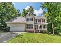 Charming two-story home featuring a well-manicured lawn, attached garage, and inviting front porch at 2750 Michelle Ct, Creedmoor, NC 27522