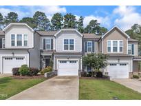 Charming townhomes with attached garages, manicured lawns, and professionally landscaped front yards at 287 White Oak Ridge Dr, Garner, NC 27529