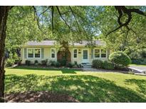 Charming one-story home featuring a brick chimney, light shutters, and a well-maintained lawn with mature trees at 3005 Piney Grove Wilbon Rd, Holly Springs, NC 27540