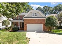 Charming brick home with a well-manicured lawn and attached two car garage at 3921 Robins Nest Ln, Wake Forest, NC 27587