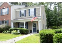 Charming two-story home with blue shutters, an American flag, and landscaped front yard at 4224 Vienna Crest Drive Dr, Raleigh, NC 27613
