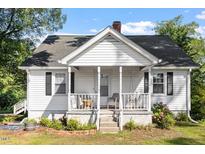 Charming home featuring a covered front porch and a cozy swing at 506 Currin St, Durham, NC 27703
