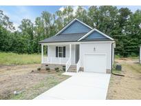 Charming single-story home with a covered porch, attached garage, and a well-manicured front yard at 510 Branch St, Rocky Mount, NC 27801