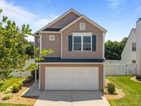 Charming two-story home with a two car garage and well-manicured lawn in a desirable neighborhood at 5300 Roan Mountain Pl, Raleigh, NC 27613