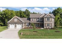 Beautiful two-story home featuring a three-car garage and a well-manicured lawn at 543 Allessandra Dr, Clayton, NC 27527