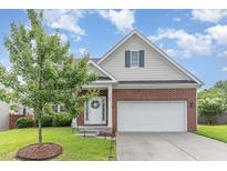 Charming brick home with a two-car garage, manicured lawn, and inviting entrance at 543 Callandale Ln, Durham, NC 27703