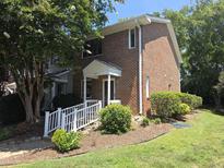 Charming red brick townhome with a well-manicured lawn and inviting entryway at 5893 Shady Grove Cir, Raleigh, NC 27609