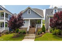 Charming home with brick foundation, landscaped yard, and welcoming staircase leading to the front porch at 690 Great Ridge Pkwy, Chapel Hill, NC 27516