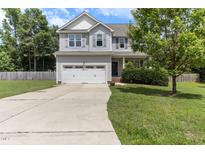 Charming two-story home features a two-car garage and a well-maintained lawn at 767 Omaha Dr, Broadway, NC 27505