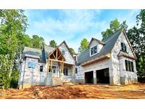 New home under construction featuring a two-car garage and a welcoming front porch at 8 Pin Tail Ct, Pittsboro, NC 27312