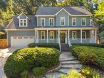 Charming home featuring stone walkway, manicured bushes, and a welcoming porch at 8412 Old Deer Trl, Raleigh, NC 27615