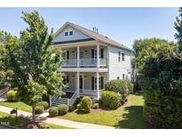 Charming two-story home with a inviting double porch and landscaped yard at 915 Chapanoke Rd, Raleigh, NC 27603