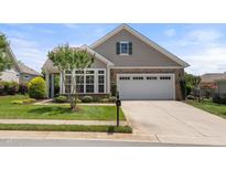 Charming home showcasing a well-manicured lawn, complemented by stone and siding accents at 102 Mikaila Dr, Gibsonville, NC 27249