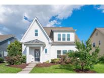 Charming two-story home boasts manicured lawn, flowerbeds, and a welcoming front entrance with decorative wreath at 1109 Hemby Ridge Ln, Morrisville, NC 27560