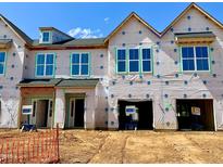 New construction townhomes featuring a modern design with large windows, and garage at 165 Ripple Way # 205, Clayton, NC 27520