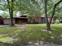 Charming brick home featuring a lovely front yard and covered porch at 194 John Mitchell Rd, Youngsville, NC 27596
