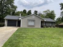 Charming single-story home featuring a well-manicured lawn, attached garage and neutral-toned exterior at 205 Woodhaven Dr, Burlington, NC 27217