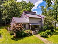 Charming two-story home with a well-maintained front yard and colorful landscaping at 206 Lisa Dr, Chapel Hill, NC 27510