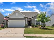 Charming single-story home featuring a two-car garage, well-maintained lawn, and inviting curb appeal at 2626 Nassau Trce, Fuquay Varina, NC 27526