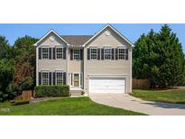 Charming two-story home with a well-manicured lawn and a two-car garage, perfect for Gathering living at 2725 Gross Ave, Wake Forest, NC 27587