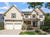 Charming two-story home featuring a stone and siding exterior, a two-car garage, and beautifully landscaped front yard at 2941 Grandview Heights Lane Ln, Raleigh, NC 27614