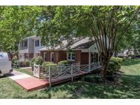 Charming brick townhouse with a unique red bridge and well-maintained landscaping enhancing curb appeal at 4600 Townesbury Ln, Raleigh, NC 27612