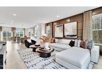 Bright living room featuring modern decor, stylish furniture, and an open-concept layout to the kitchen at 5032 Jowetts Walk Dr # 26, Cary, NC 27519