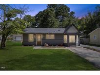 Charming single-story home featuring a freshly painted exterior and a well-manicured front lawn at 506 W Walnut St, Selma, NC 27576