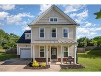 Charming two-story home featuring a welcoming front porch and well-manicured lawn at 605 Bellefont Ct, Knightdale, NC 27545