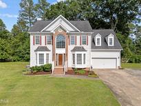 Beautiful two-story home featuring a brick facade, dormer windows, and a well-manicured front lawn at 8 Summertime Ct, Durham, NC 27707