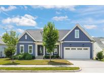 Charming single-Gathering home with a blue exterior, well-manicured lawn, and a two-car garage at 815 Laurelwood Dr, Durham, NC 27705