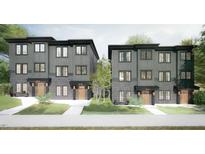 Charming townhomes feature modern design, gray siding, brick accents, and well-manicured landscaping for curb appeal at 1017 N Buchanan Blvd # C, Durham, NC 27701