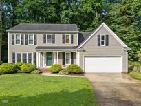 Charming two-story home featuring a well-manicured lawn and attached two-car garage at 120 E Laurenbrook Ct, Cary, NC 27518