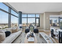 Bright, spacious living room features expansive windows with city views and modern decor at 122 N Harrington St # 1025, Raleigh, NC 27603