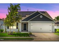 Charming one-story home with a well-manicured lawn, an attached garage and a installed Solar Panels at 1561 Dorsett Ln, Creedmoor, NC 27522