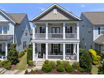 Charming two-story home with double porches and well-maintained landscaping at 1604 Upper Park Rd, Wake Forest, NC 27587